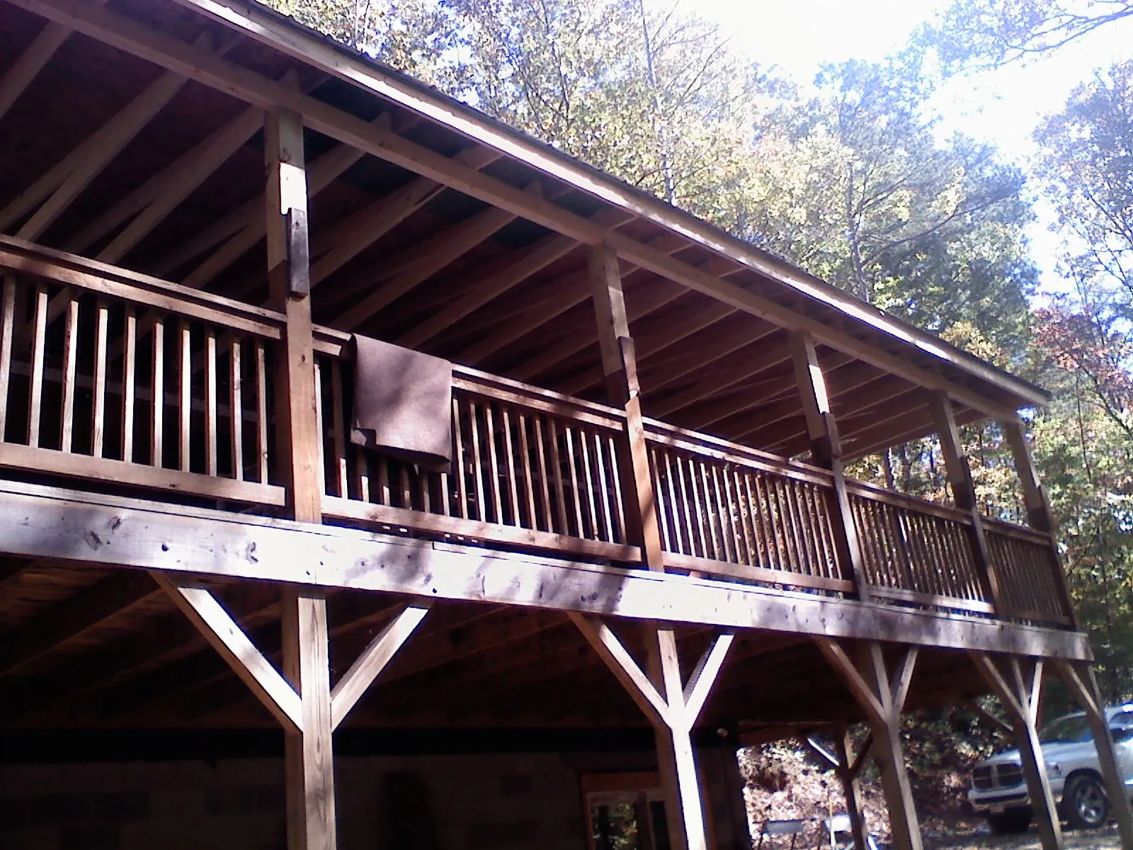 Timber framing under a new elevated porch and deck in Udall